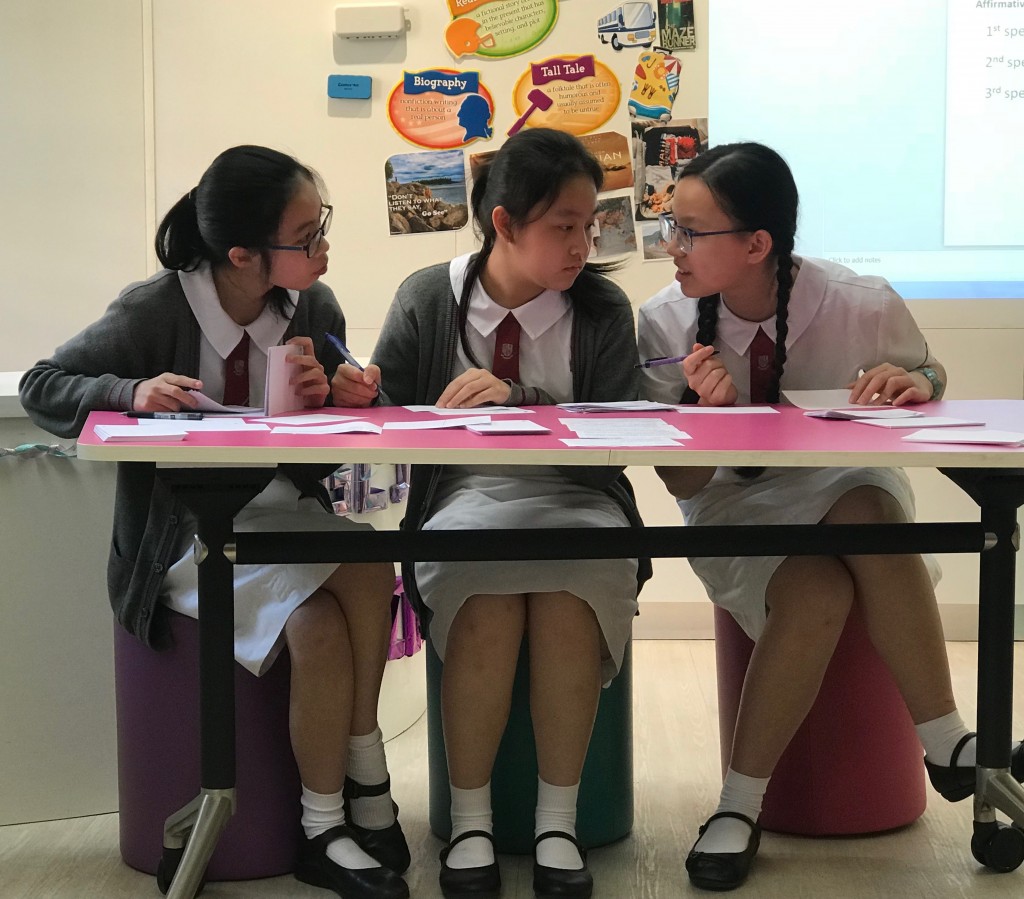 2B Fiona Chen, 2A Michelle Mak and 2D Kennis Cheung in the HKPTU English Debating Competition