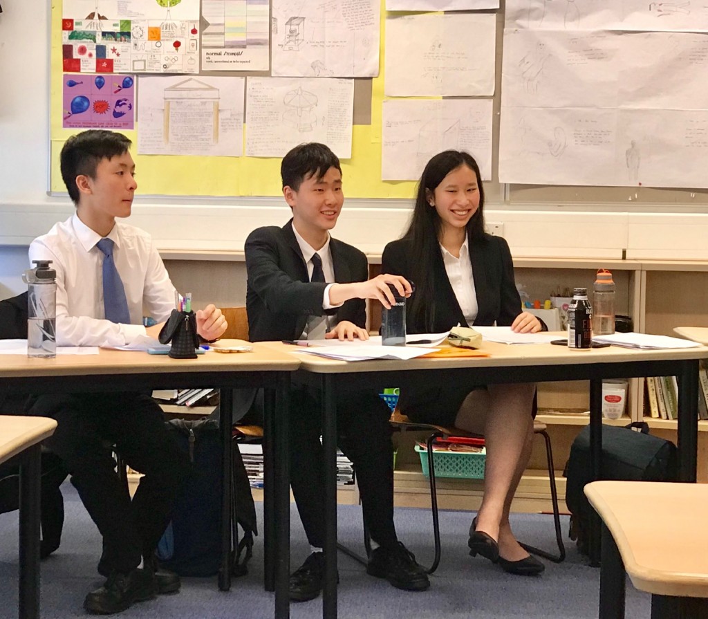 5B Isaac Lee, 6B David Tse and 5A June Kan debating in the quarter-finals in the Senior Debating Championships